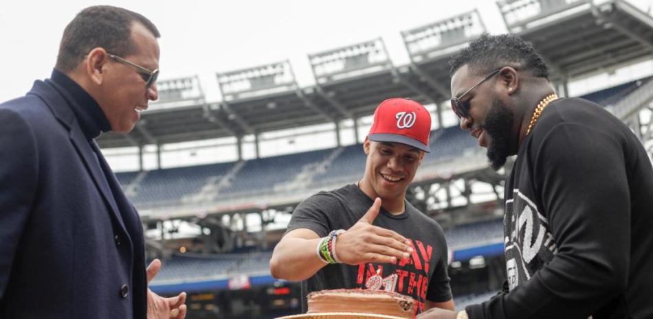 Three men celebrating with birthday cake