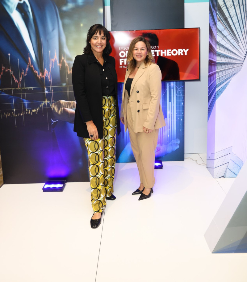 Two women presenting with display screens