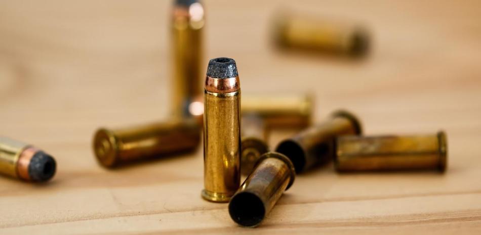 Bullets scattered on wooden table