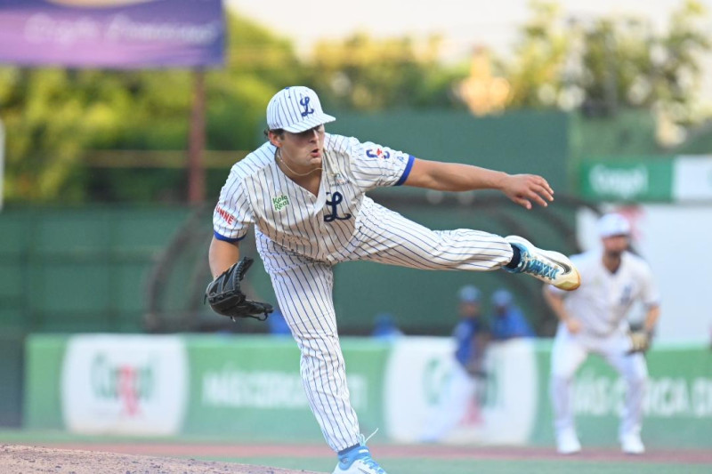 Pitcher throwing baseball on mound