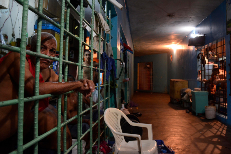 Prisoner in concrete jail cell