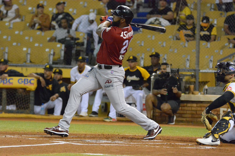 Baseball player swings bat