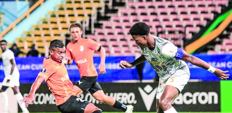 Futbolistas compiten en estadio iluminado