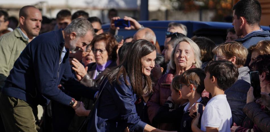 Mujer sonriente saluda a multitud