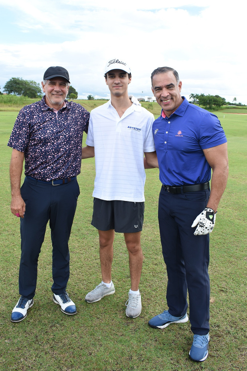 Tres golfistas posando en campo verde