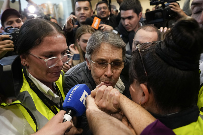 Dos personas sostienen un micrófono