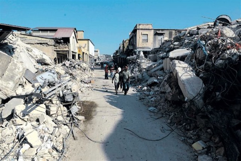 Personas caminando por calle destruida