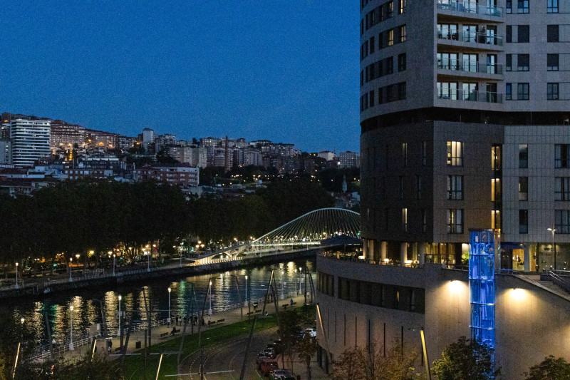 Puente iluminado sobre ciudad nocturna