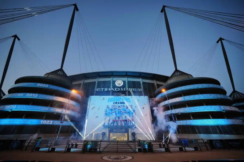 Estadio Etihad iluminado al atardecer